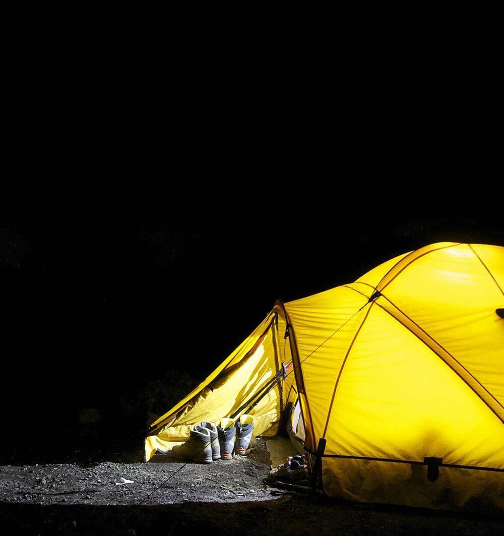 yellow camping tent shining in the night